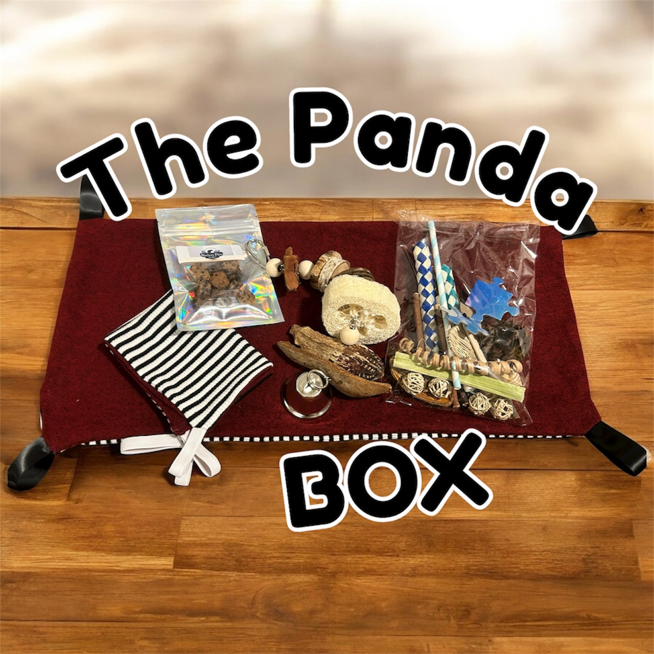 Collection of items for rats on a red blanket with 'The Panda Box' text.